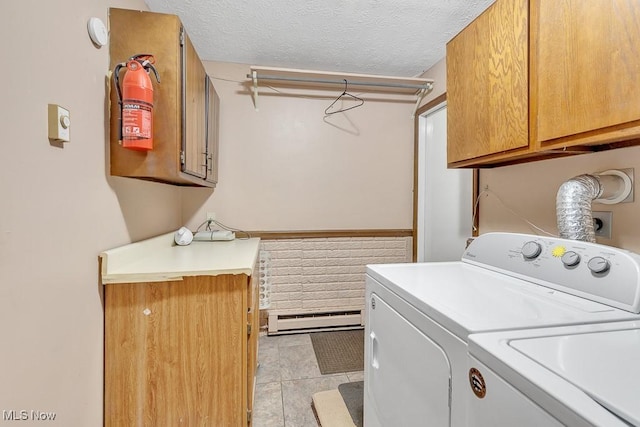 clothes washing area with cabinet space, light tile patterned floors, independent washer and dryer, a textured ceiling, and a baseboard heating unit