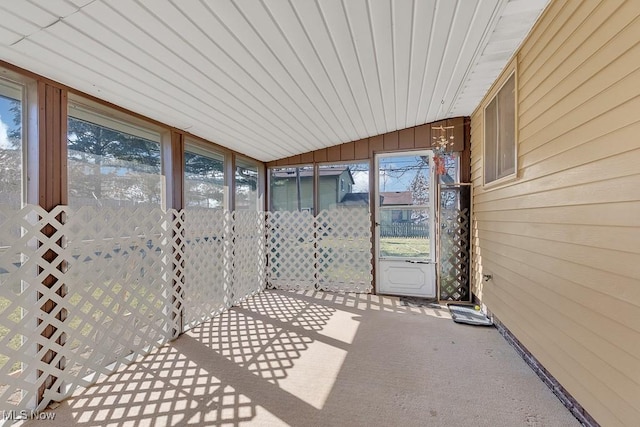 unfurnished sunroom with lofted ceiling and a healthy amount of sunlight