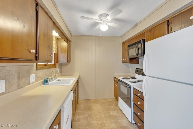 kitchen featuring white appliances, tasteful backsplash, brown cabinetry, light countertops, and a sink