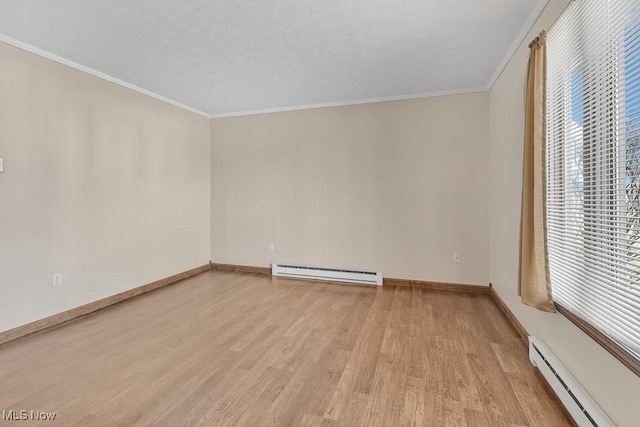 unfurnished room with plenty of natural light, baseboard heating, a baseboard radiator, and light wood-style flooring