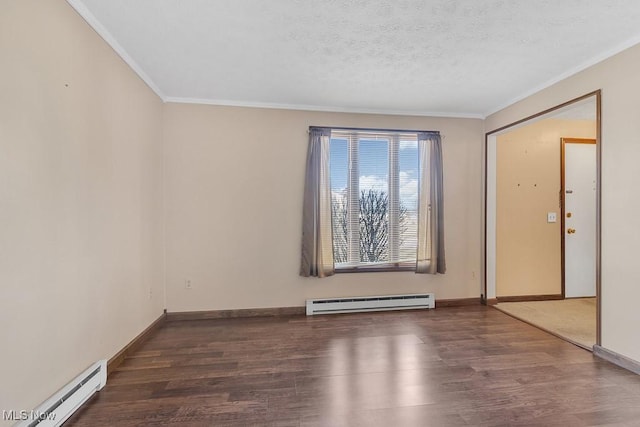 spare room featuring a textured ceiling, ornamental molding, baseboard heating, and wood finished floors