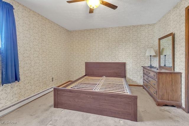 bedroom featuring wallpapered walls, baseboards, a baseboard heating unit, and carpet flooring