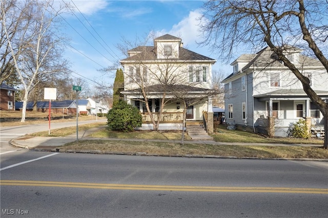 american foursquare style home with a porch