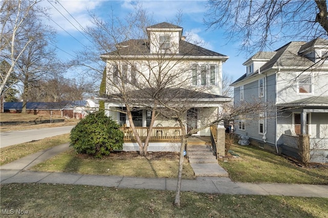 traditional style home with a porch and a front lawn