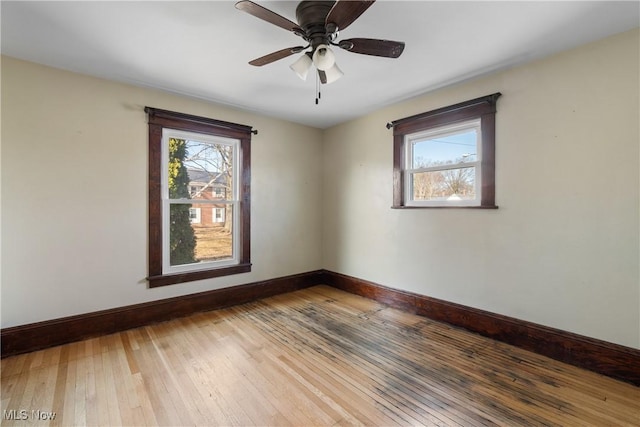 unfurnished room featuring light wood-style floors, ceiling fan, and baseboards