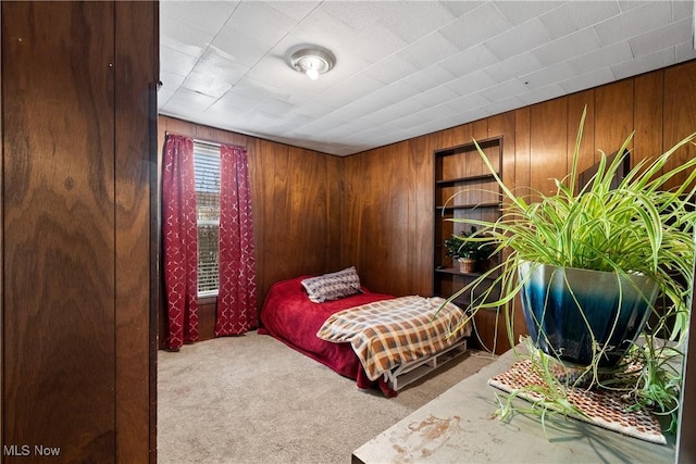 bedroom with carpet and wooden walls