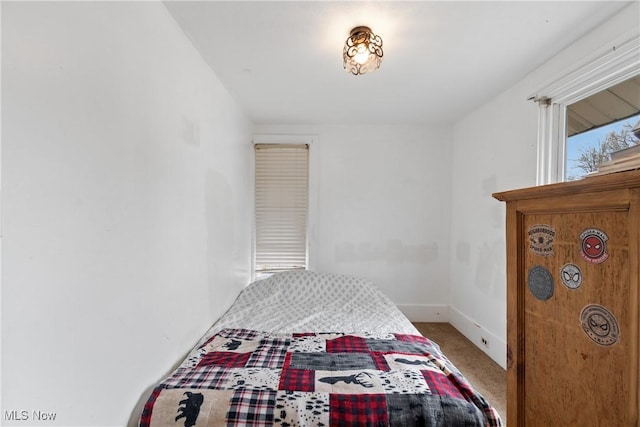 bedroom with carpet flooring and baseboards