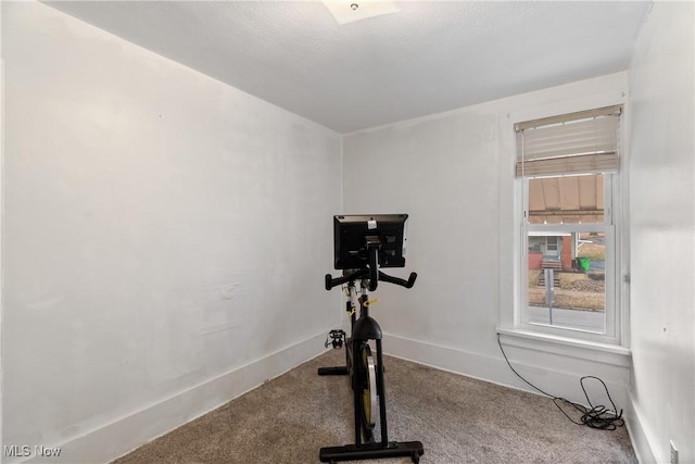 exercise area with carpet flooring and baseboards