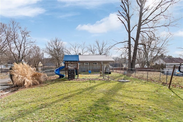 view of yard featuring a fenced backyard and a playground