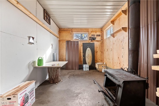 interior space featuring concrete floors and wood walls