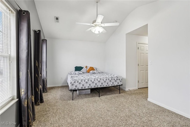 bedroom with lofted ceiling, baseboards, visible vents, and carpet