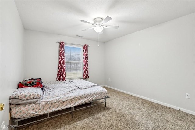 carpeted bedroom featuring ceiling fan, visible vents, and baseboards