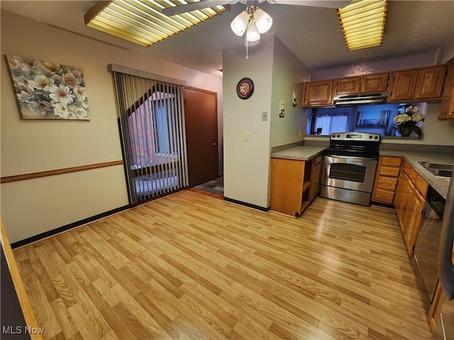 kitchen featuring stainless steel appliances, brown cabinetry, under cabinet range hood, and light wood finished floors