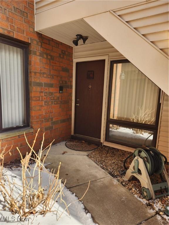 property entrance with brick siding