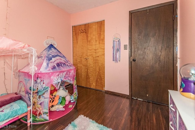 bedroom with baseboards and wood finished floors