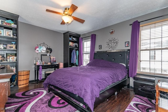 bedroom featuring ceiling fan, a textured ceiling, and wood finished floors