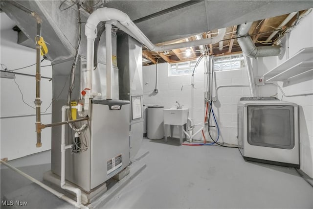 utility room featuring washer / clothes dryer, a sink, and heating unit