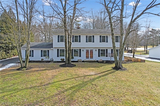 colonial home featuring a front yard