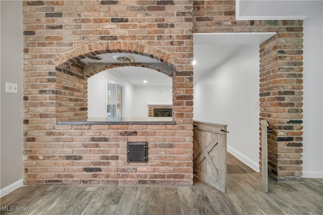 interior space with baseboards and wood finished floors