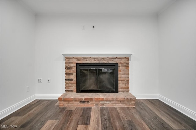 details featuring a fireplace, baseboards, and wood finished floors