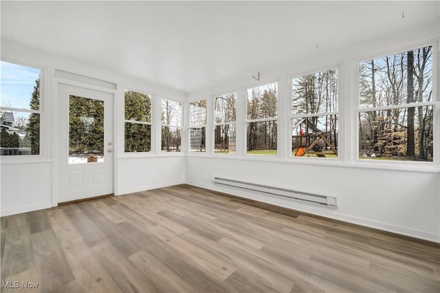 unfurnished sunroom featuring a baseboard heating unit