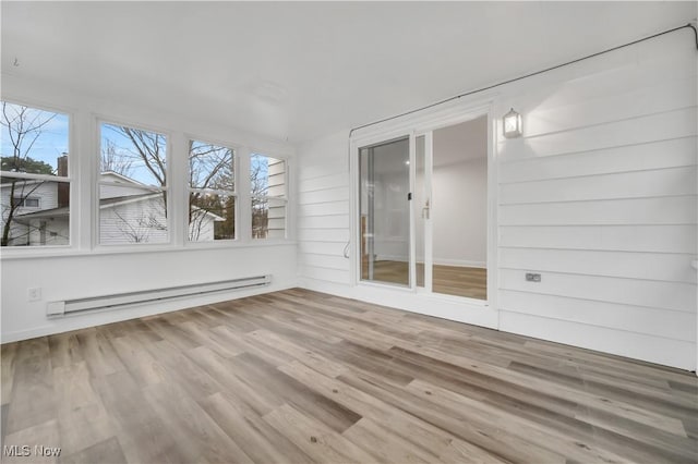 unfurnished sunroom with plenty of natural light and a baseboard radiator