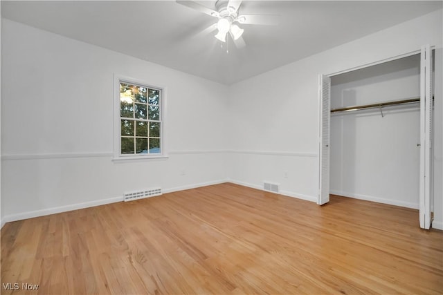 unfurnished bedroom with light wood-type flooring, baseboards, visible vents, and a closet