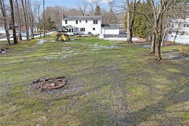 view of yard with a fire pit and a playground