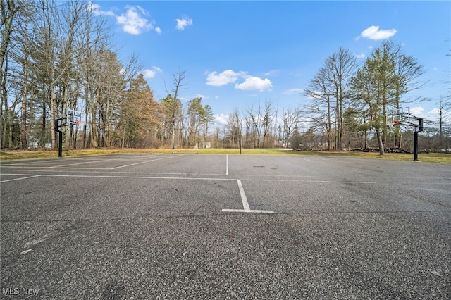 uncovered parking lot with community basketball court