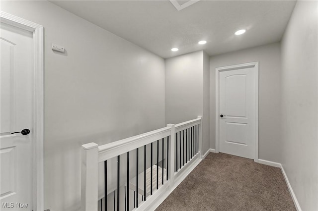 corridor with carpet floors, recessed lighting, and baseboards