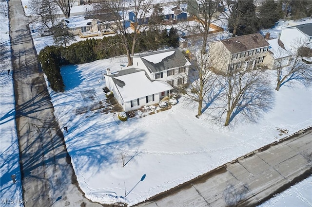 snowy aerial view with a residential view