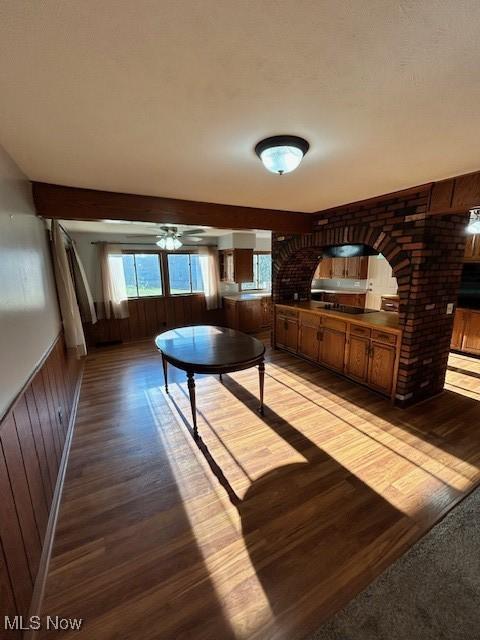 unfurnished dining area with wood walls and light wood-style flooring