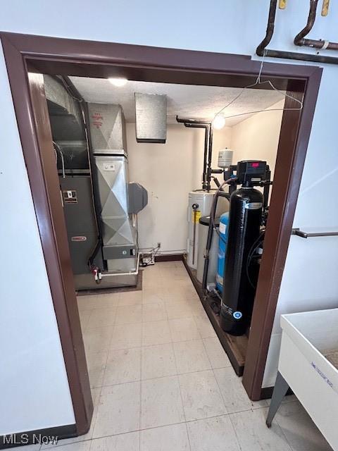 utility room featuring gas water heater