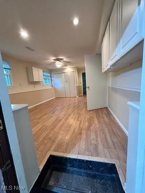 interior space featuring recessed lighting, visible vents, light wood-style flooring, and baseboards