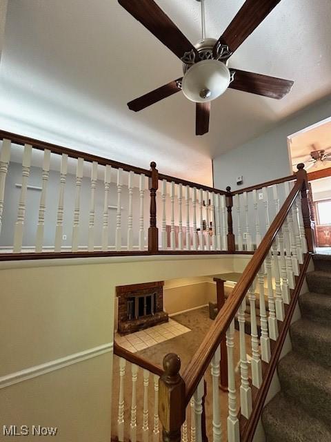 stairway with ceiling fan