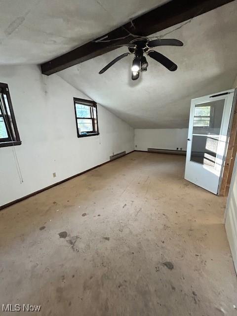 additional living space featuring vaulted ceiling with beams, ceiling fan, baseboards, and baseboard heating