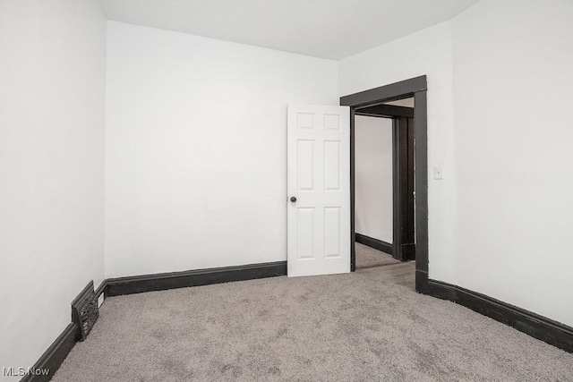 spare room with carpet floors and baseboards