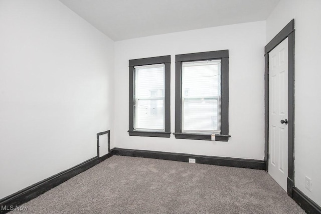 empty room with carpet floors and baseboards