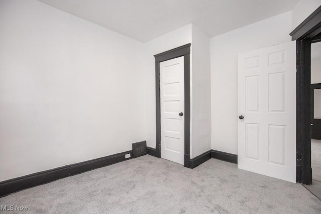 unfurnished bedroom featuring carpet, visible vents, and baseboards