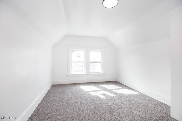 bonus room with lofted ceiling, carpet floors, and baseboards