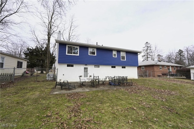 back of house with stucco siding, a fenced backyard, a patio, and a yard