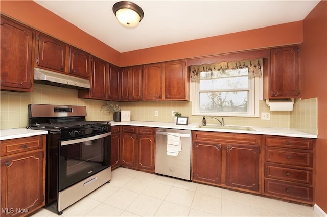 kitchen with stainless steel appliances, a sink, light countertops, and under cabinet range hood