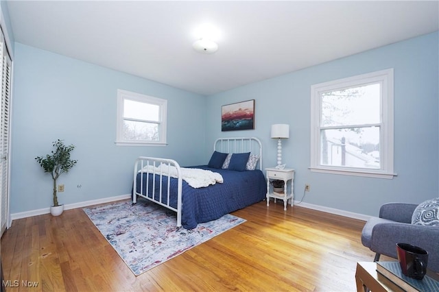 bedroom with light wood-style floors and baseboards