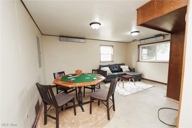 recreation room featuring concrete floors and baseboards