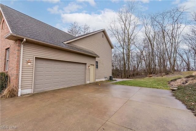 view of home's exterior with central AC, driveway, roof with shingles, and a garage