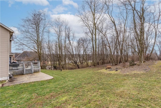 view of yard with a patio area and a wooden deck