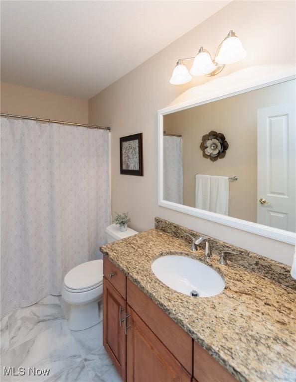 full bathroom with marble finish floor, vanity, and toilet