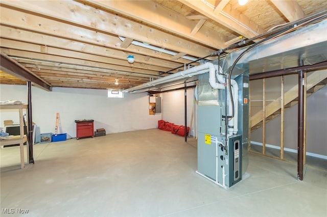 basement featuring electric panel and heating unit