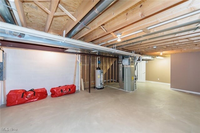 unfinished below grade area with gas water heater, baseboards, and heating unit