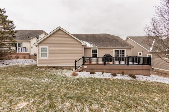 rear view of property featuring a wooden deck